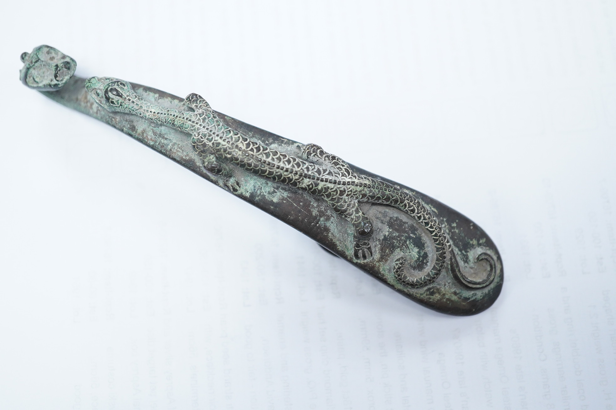 A Chinese bronze belt hook, Song Dynasty or later, 13.5cm wide. Condition - good condition for age